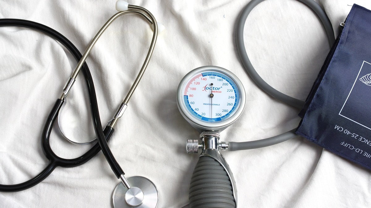 a stethoscope laying on top of a bed next to a medical bag